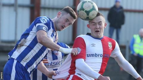 Coleraine Stephen O'Connell challenges Linfield forward Michael O'Connor