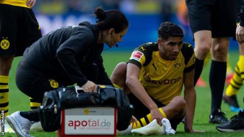 Morocco's Achraf Hakimi being attended to by Dortmund medical staff