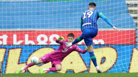 Kieffer Moore's first goal for Wigan, scored from the penalty spot, proved in vain against Swansea