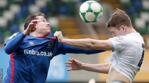Linfield's Marek Cervenka competes with Ballymena defender Jonathan Addis