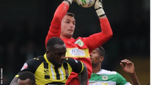 Yeovil goalkeeper Artur Krysiak collects a corner against Dagenham and Redbridge