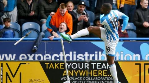 Huddersfield's Isaac Mbenza breaks the corner flag after scoring against Manchester United