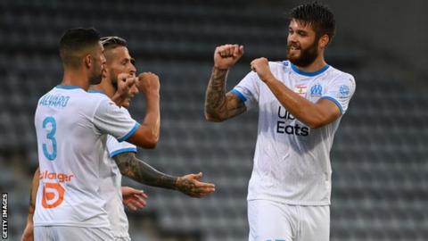 Marseille players celebrate a goal in a friendly against Nimes