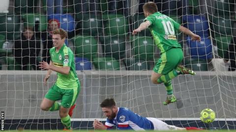 Goalscorer Ross Lavery wheels away to celebrate after scoring Cliftonville's late winning goal against Linfield