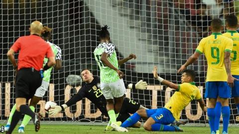 Joe Aribo fires past Brazil goalkeeper Ederson to open the scoring in a 1-1 friendly result in Singapore