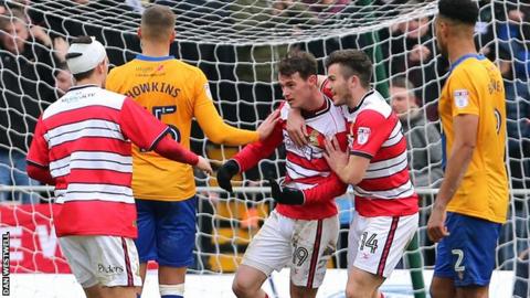 Doncaster Rovers' Liam Mandeville celebrates his penalty against Mansfield