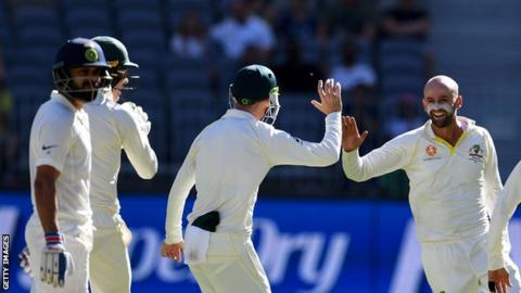 Nathan Lyon celebrates taking the wicket of India captain Virat Kohli