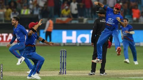 Afghanistan players celebrate the wicket of Jadeja