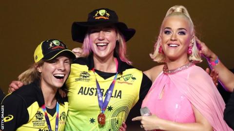 Australia's Ellyse Perry (centre) with a team-mate and singer Katy Perry