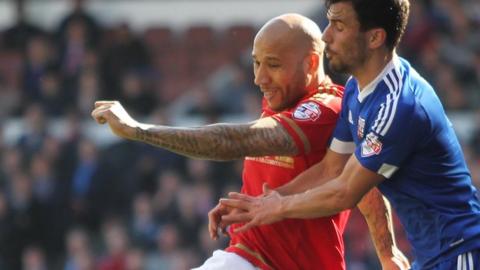 Kelvin Wilson of Nottingham Forest (L) and Maxime Colin of Brentford