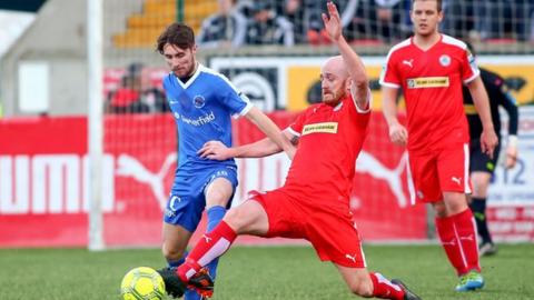 Ryan Catney battles with Ballinamallard's Ryan Mayse in November 2016