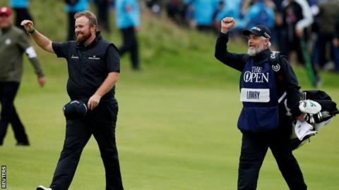 Shane Lowry and his caddie Brian 'Bo' Martin celebrate as they walk to the 18th green on Sunday