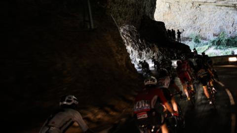 Grotte du Mas d'Azil, France, 24 July: Riders travel through a natural cave during the 16th stage of the 105th Tour de France, between Carcassonne and Bagneres-de-Luchon. (Photo by Jeff Pachoud/AFP/Getty Images)
