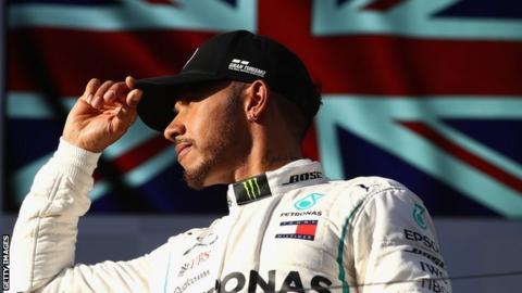 Lewis Hamilton stands on the podium in Melbourne