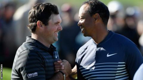 Tiger Woods (right) shakes hands with Patrick Reed
