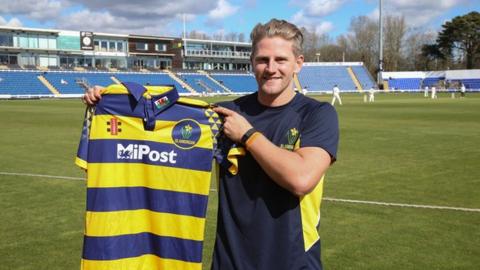 Timm van der Gugten holds up a Glamorgan shirt
