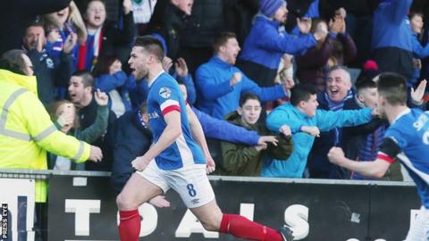 Stephen Lowry runs away in delight after scoring Linfield's opener against Crusaders