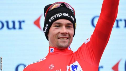 Primoz Roglic celebrates on the podium after stage 20 of the Vuelta a Espana