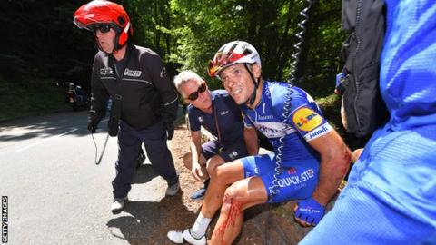 Philippe Gilbert at the side of the road after a fall during the 16th stage of the race