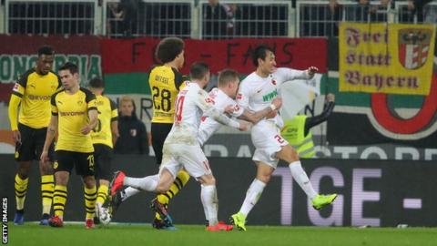 Augsburg players celebrate Ji Dong-won's goal