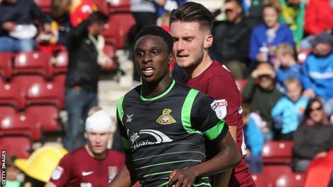 Doncaster Rovers midfielder Rodney Kongolo holds off Northampton midfielder Matt Grimes
