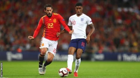England goalscorer Marcus Rashford competes with Isco