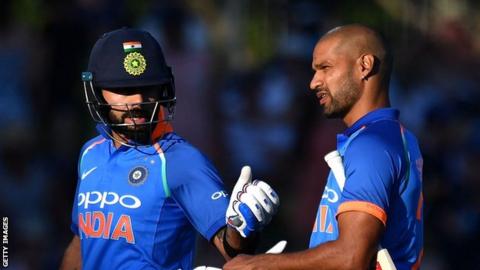 India captain Virat Kohli and opener Shikhar Dhawan walk off the field in Napier after the sun halted play against New Zealand