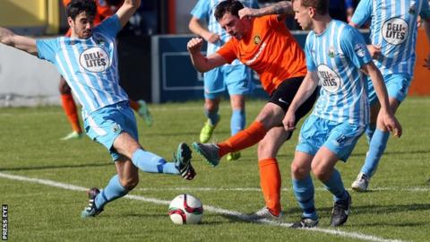 Darren King and Carrick forward Gary Browne clash in Warrenpoint's 2-1 league win in September