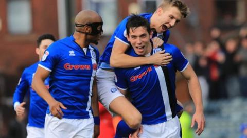 Niall Canavan celebrates scoring Rochdale's opener with Calvin Andrew and Mark Kitching in the 3-3 home draw with Charlton Athletic