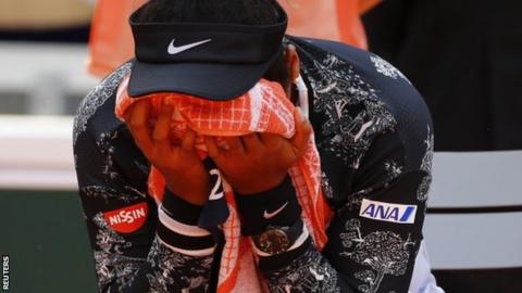 Naomi Osaka with her head in her towel