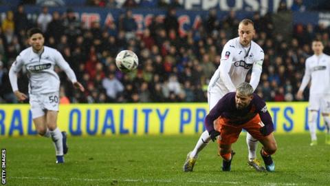 Sergio Aguero stoops to head in Manchester City's winner against Swansea