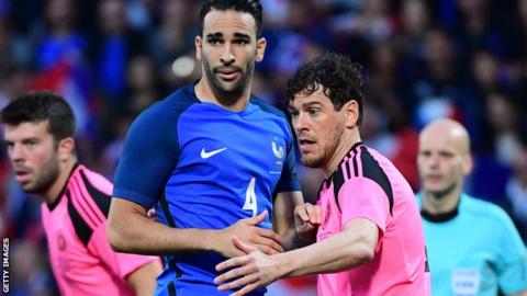 Adil Rami of France is marked by Scotalnd's Gordon Greer