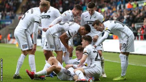George Byers celebrates scoring with his team-mates