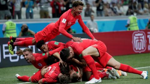 England's players celebrate scoring against Tunisia