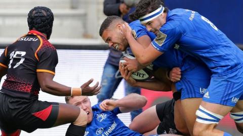 Leinster's Max Deegan supports try scorer Adam Byrne over the line