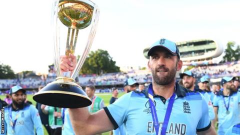 Liam Plunkett holds the Cricket World Cup trophy aloft at Lord's