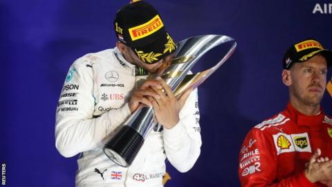Lewis Hamilton celebrates on the podium at the Singapore Grand Prix