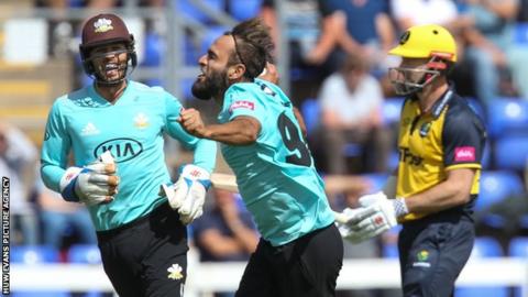 Surrey's Imran Tahir celebrates after taking the wicket of Shaun Marsh