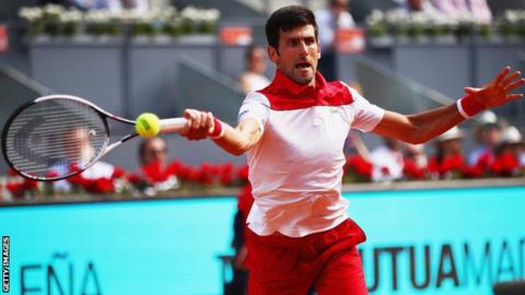 Novak Djokovic plays a forehand during his first round match against Kei Nishikori at the Madrid Open