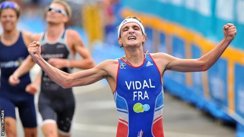 Laurent Vidal celebrates victory in a Triathlon World Series event