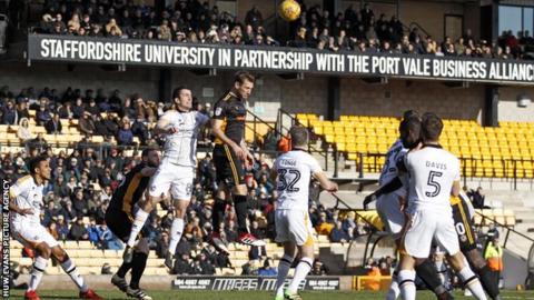 Mickey Demetriou of Newport County tries to head the ball