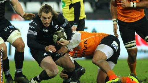 Jeff Hassler of Ospreys is tackled by Nico Lee of Cheetahs