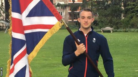 BMX rider Ross Cullen holds up the Union Jack after being selected as Team GB's flag-bearer at the Youth Olympics opening ceremony