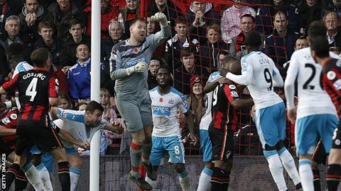 Rob Elliot (in grey) punches clear at Bournemouth