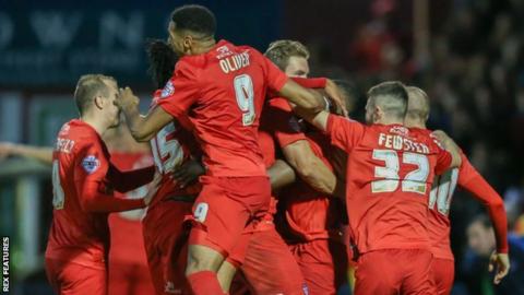 James Berrett is mobbed by his teammates after scoring what proved to be the winner