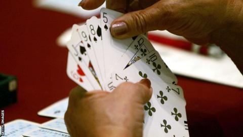 Someone playing a game of bridge