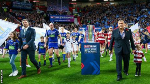Steve Price (left) leads out Warrington Wolves at Old Trafford