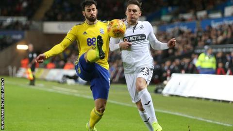 Connor Roberts of Swansea City is tackled by Maxime Colin of Birmingham City