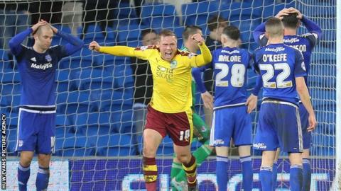 Matt Connolly (left) holds his head after scoring Burnley's equaliser