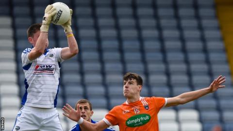 Laois goalkeeper Graham Brody makes a high catch above Armagh's Niall Grimley
